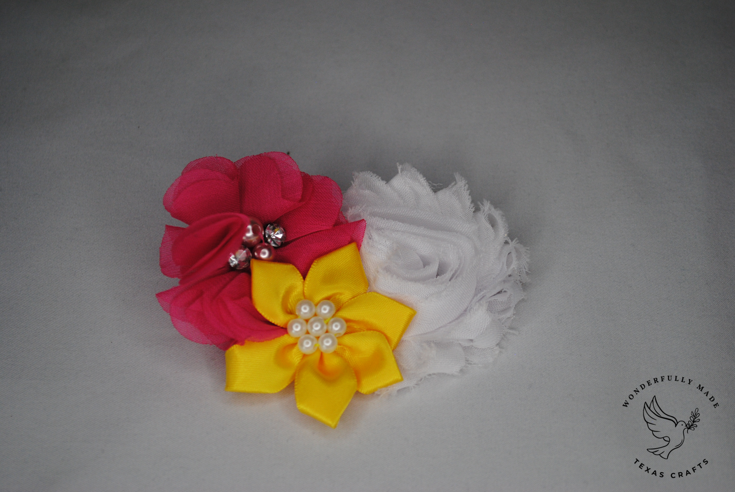 Pink, yellow and white flower clip